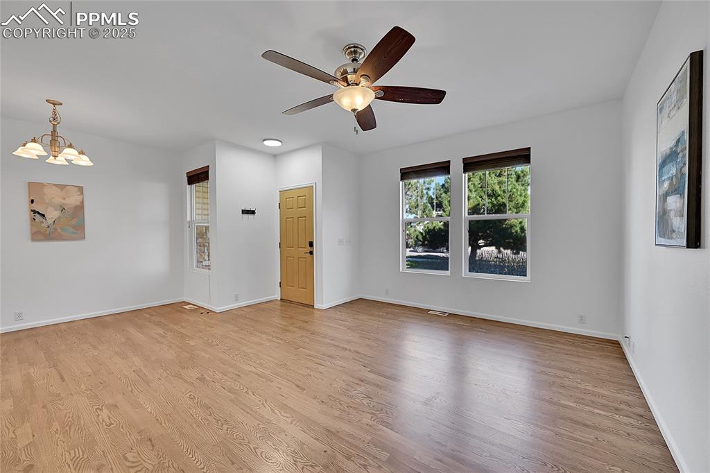 6232 Sierra Grande Point Colorado Springs, CO 80923 - Photo 5 of 31 a view of an empty room with wooden floor and a window