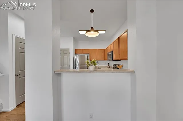 a view of a kitchen with granite countertop cabinets and a refrigerator