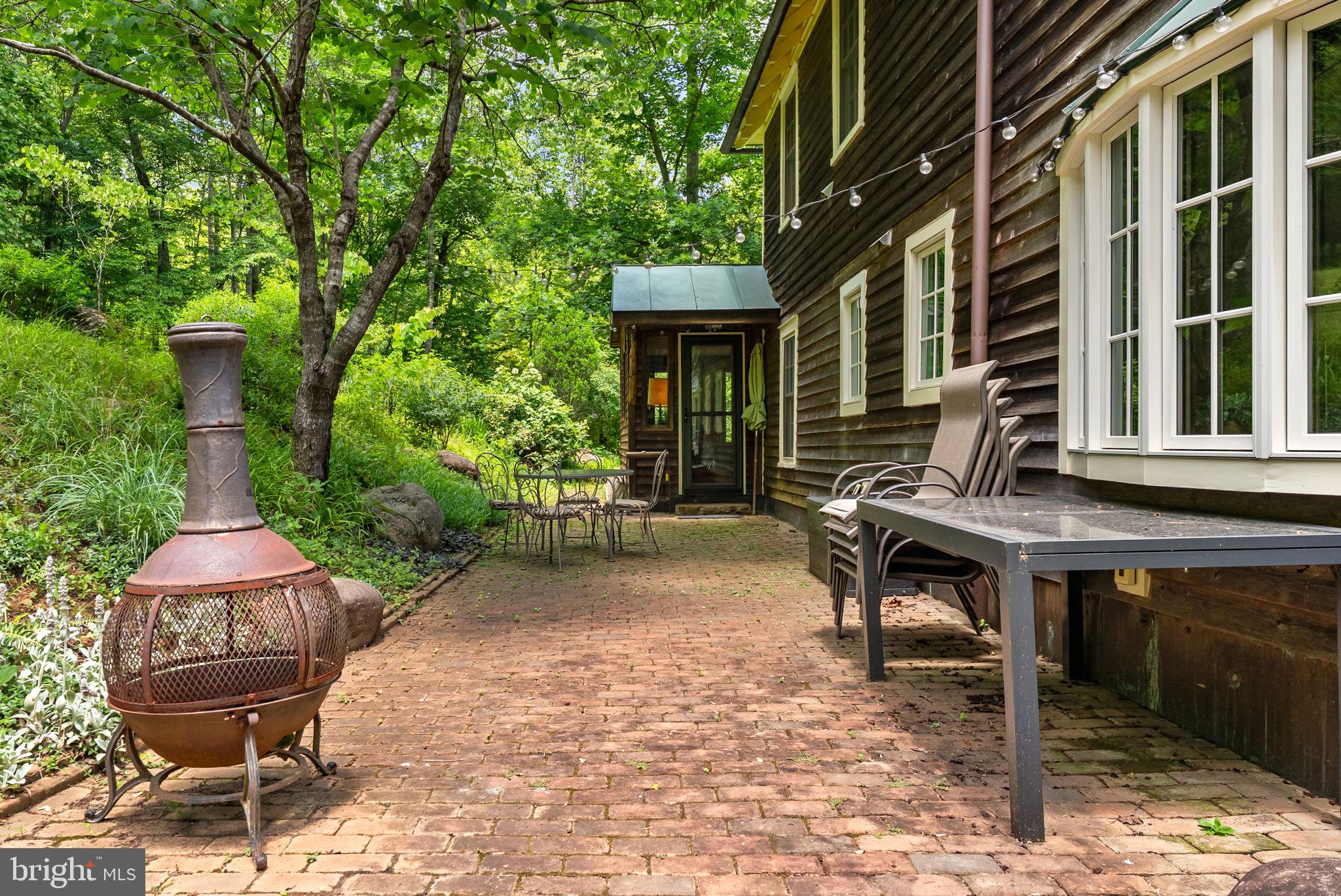 9406 Obannons Mill Road Boston, VA 22713 - Photo 30 of 34 A chiminea adds to the ambiance of outdoor dining