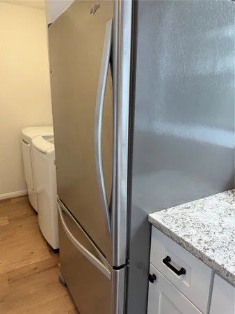a view of a storage and utility room with washer and dryer