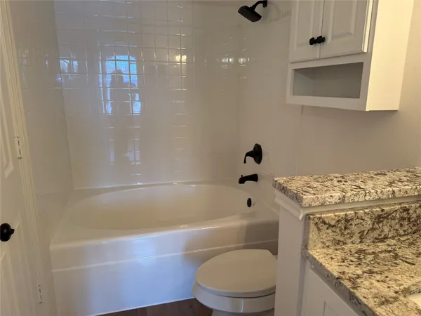 a bathroom with a sink a toilet and bathtub