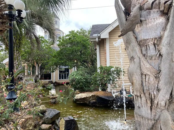 a view of a house with a yard and sitting area