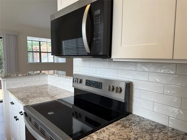 a kitchen with a stove and a microwave