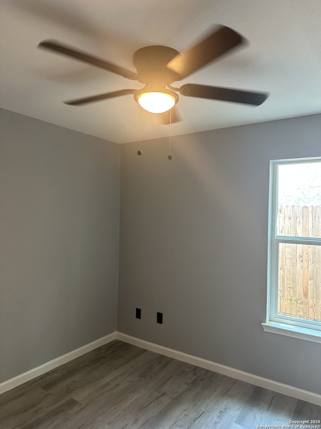 14627 Highland Ridge San Antonio, TX 78233 - Photo 11 of 25 an empty room with wooden floor and windows