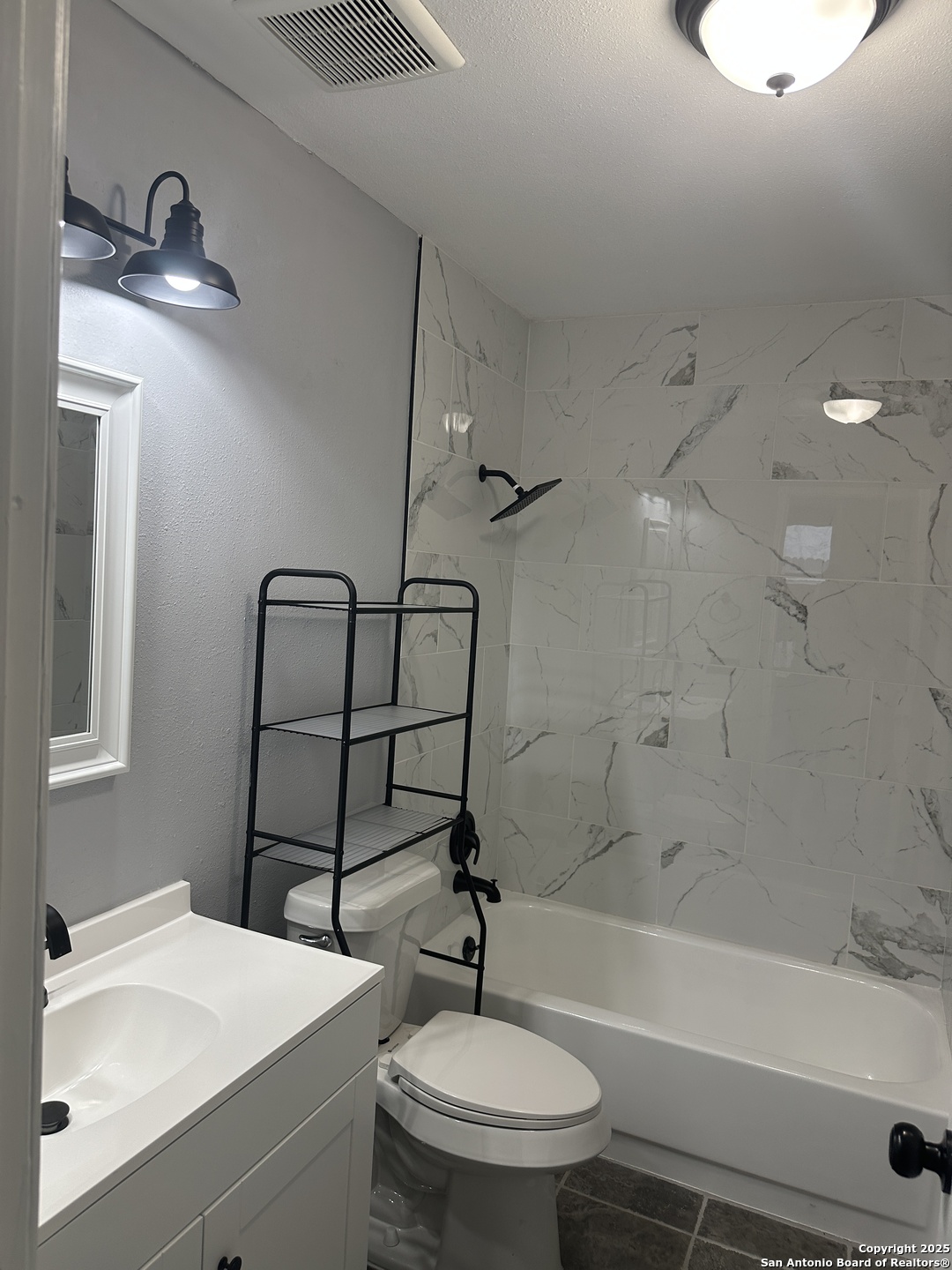 14627 Highland Ridge San Antonio, TX 78233 - Photo 12 of 25 a bathroom with a sink a toilet and shower