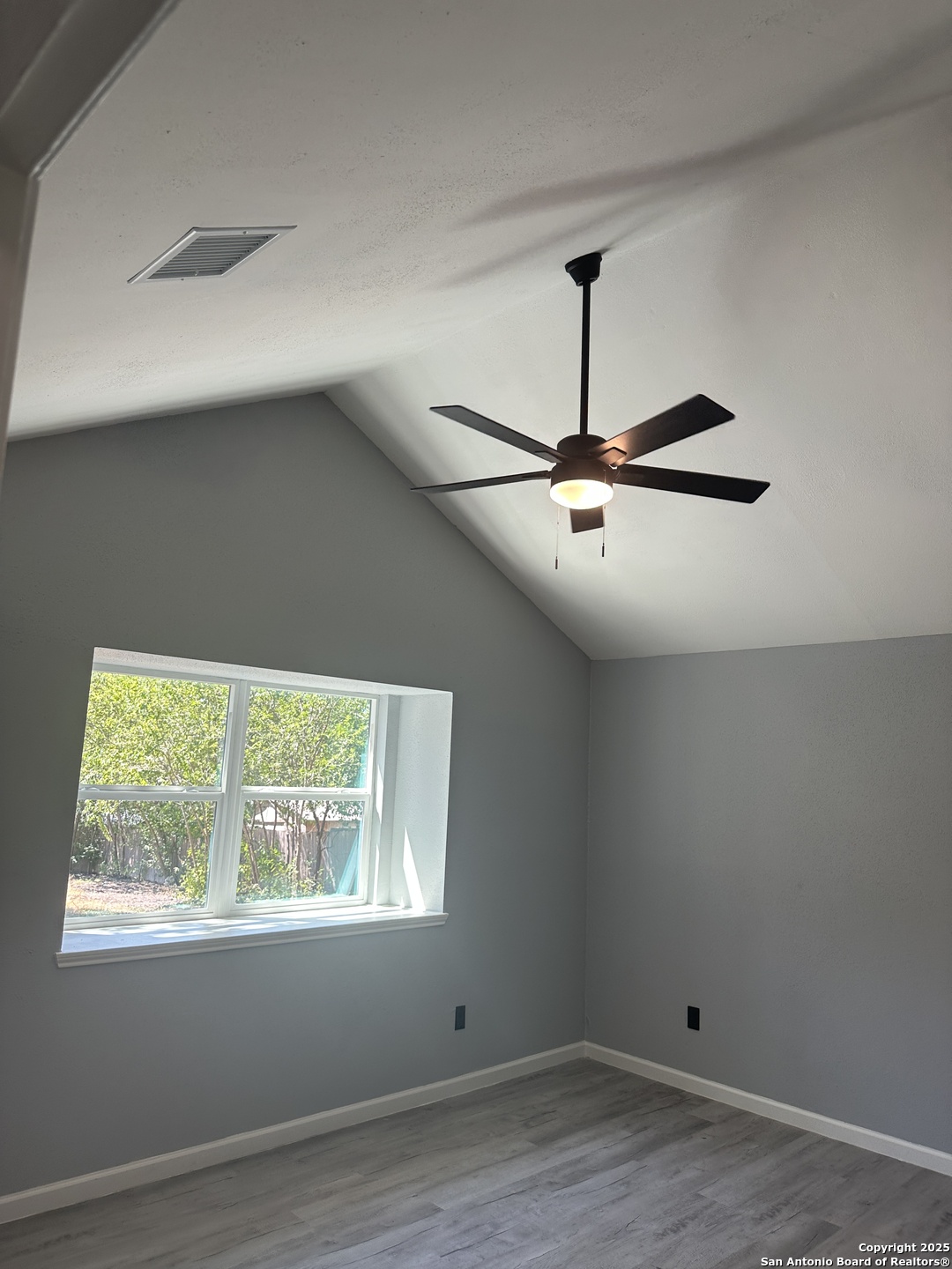 14627 Highland Ridge San Antonio, TX 78233 - Photo 16 of 25 an empty room with wooden floor ceiling fan and windows