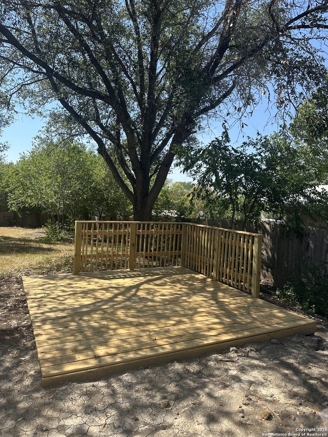 14627 Highland Ridge San Antonio, TX 78233 - Photo 21 of 25 a view of backyard with large trees and wooden fence