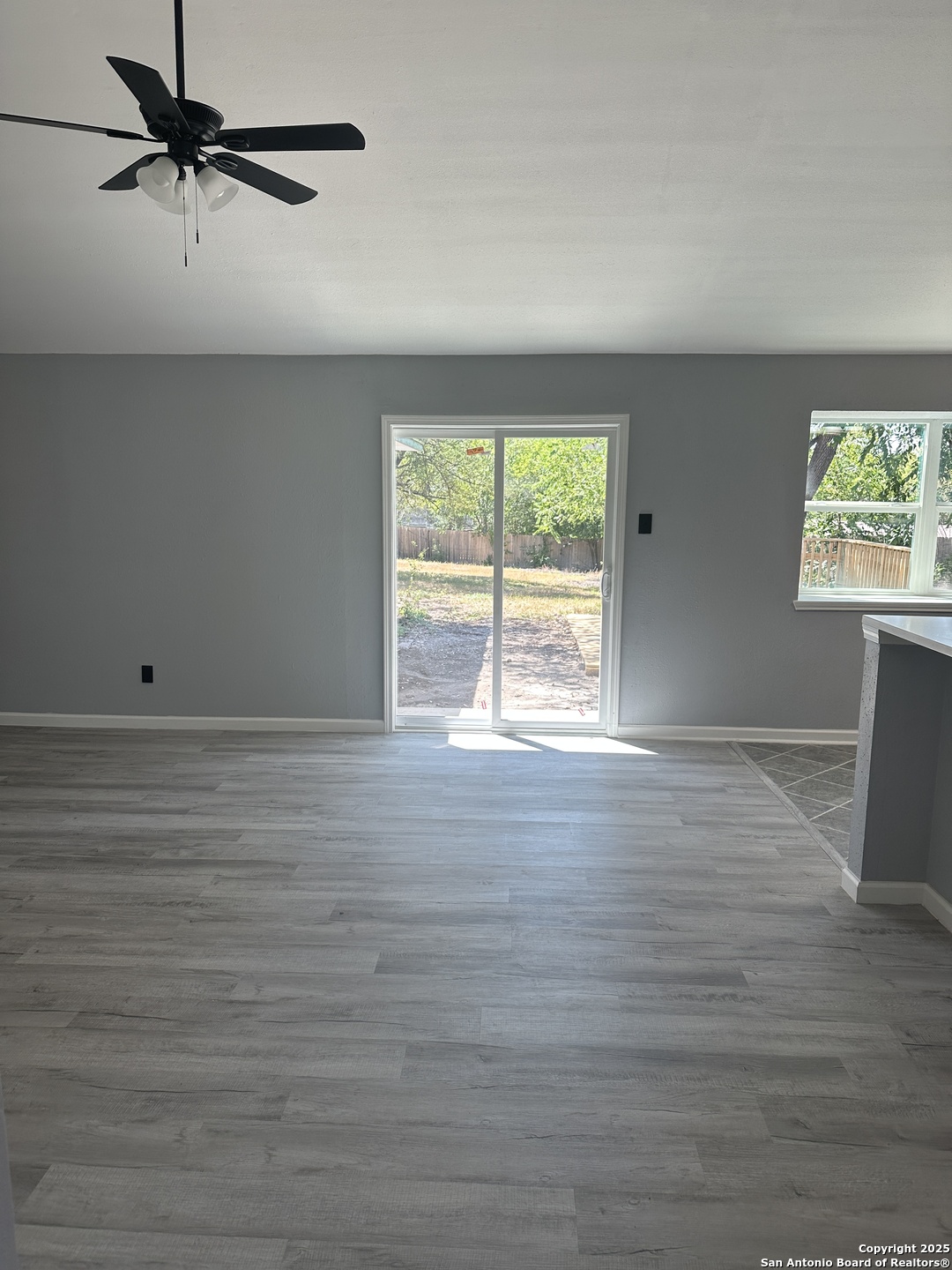 14627 Highland Ridge San Antonio, TX 78233 - Photo 5 of 25 wooden floor in an empty room with a window