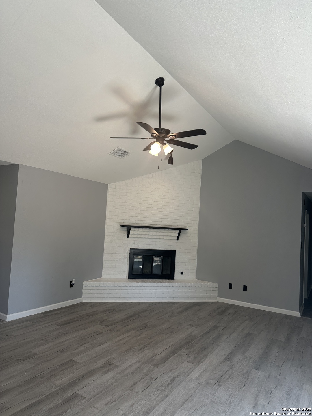 14627 Highland Ridge San Antonio, TX 78233 - Photo 6 of 25 a view of an empty room with wooden floor fireplace and a window