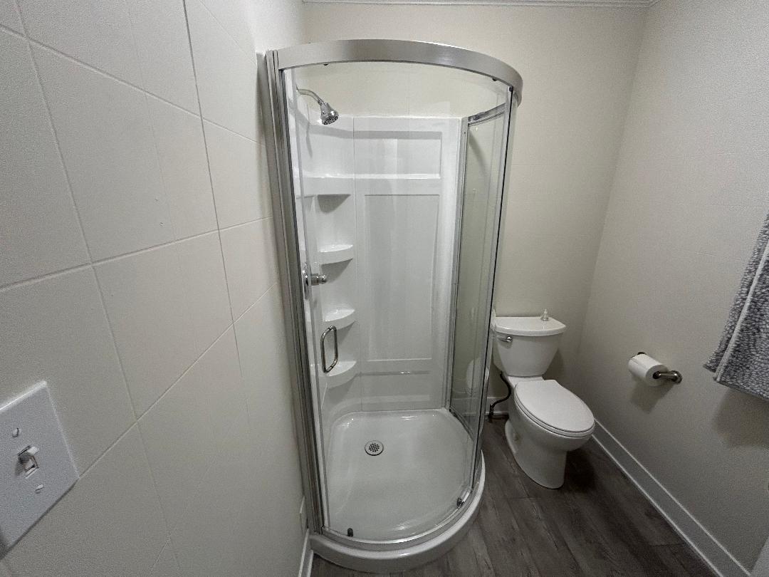 369 North Independence Boulevard Romeoville, IL 60446 - Photo 19 of 36 a white toilet sitting next to a bathroom sink and a mirror