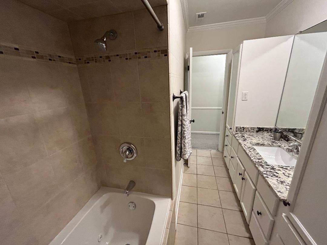 369 North Independence Boulevard Romeoville, IL 60446 - Photo 27 of 36 a bathroom with a granite countertop sink a mirror and a bathtub