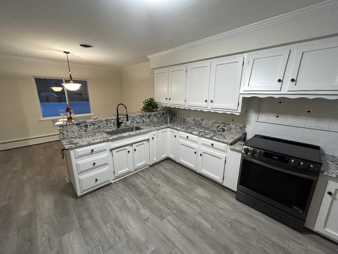 369 North Independence Boulevard Romeoville, IL 60446 - Photo 3 of 36 a kitchen with granite countertop white cabinets and white appliances