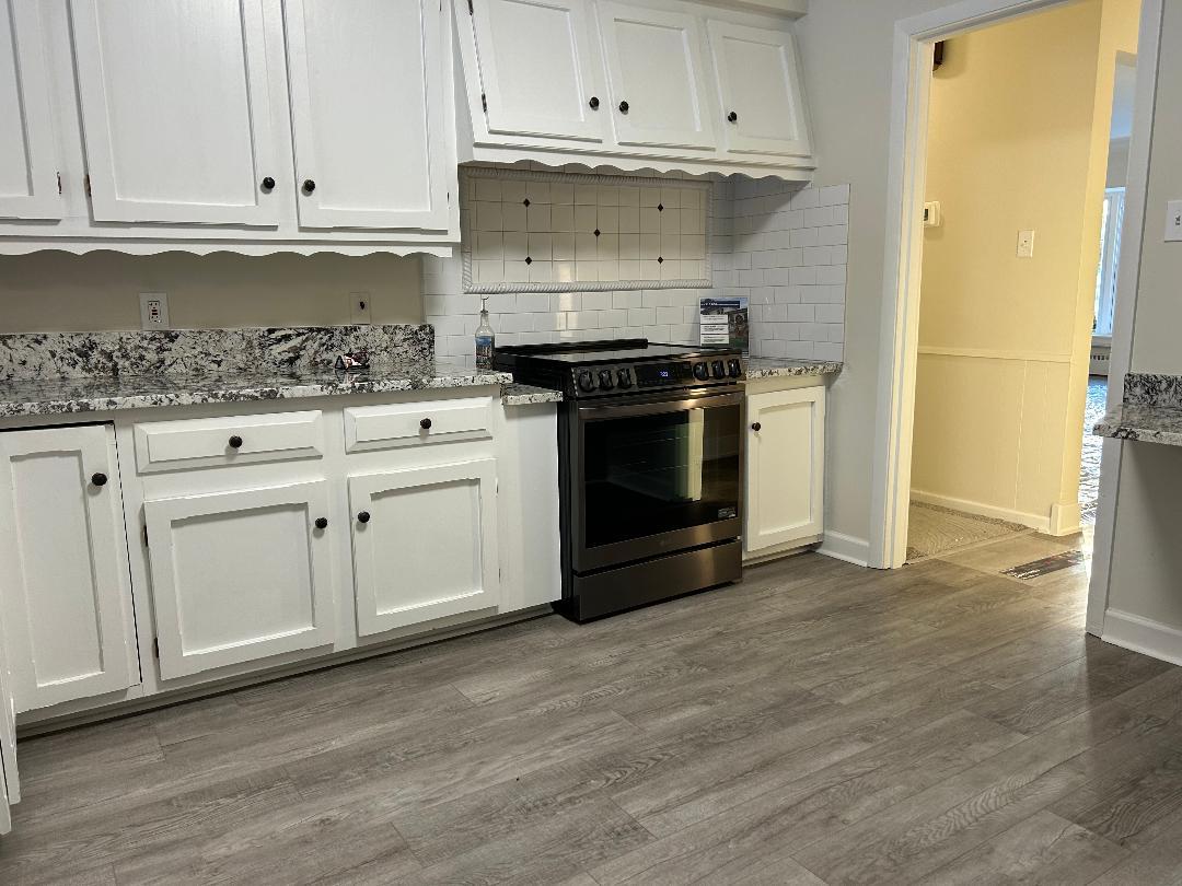 369 North Independence Boulevard Romeoville, IL 60446 - Photo 7 of 36 a kitchen with granite countertop white cabinets and stainless steel appliances