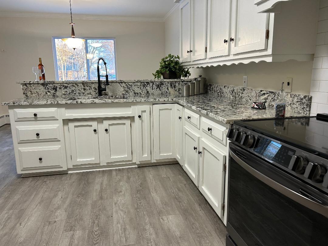369 North Independence Boulevard Romeoville, IL 60446 - Photo 8 of 36 a kitchen with granite countertop white cabinets and white appliances