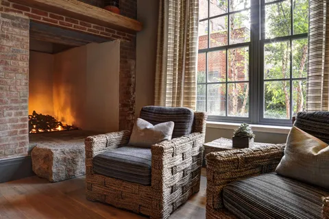 a front view of a house with sitting area