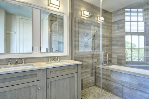 a bathroom with a shower sink and mirror