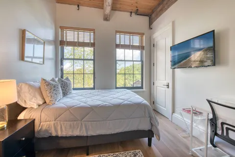 a bedroom with a bed and a flat screen tv