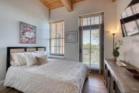 a bedroom with a bed and a window