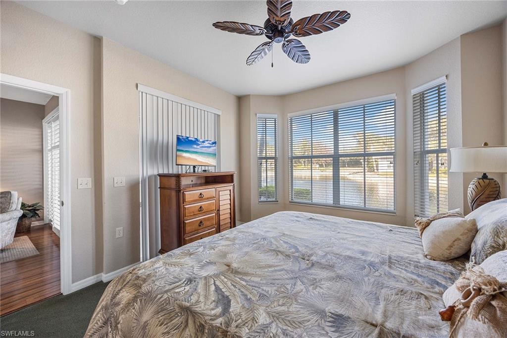 Undisclosed Address Naples, FL 34113 - Photo 13 of 38 a bedroom with a large bed and a flat tv screen