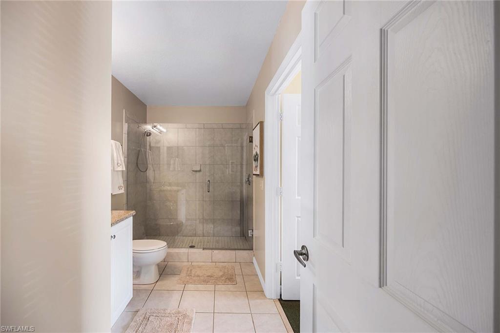 Undisclosed Address Naples, FL 34113 - Photo 17 of 38 a bathroom with a glass door shower