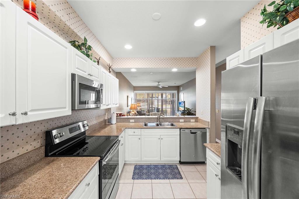 Undisclosed Address Naples, FL 34113 - Photo 8 of 38 a kitchen with stainless steel appliances granite countertop a sink stove and refrigerator