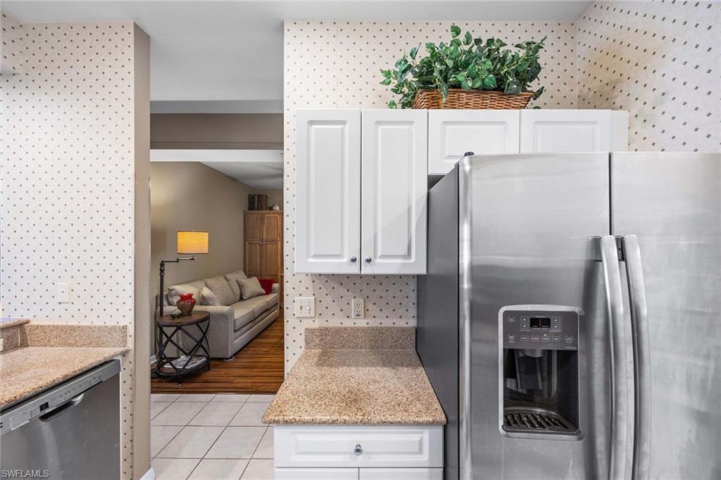 Undisclosed Address Naples, FL 34113 - Photo 9 of 38 a kitchen with a refrigerator and a sink