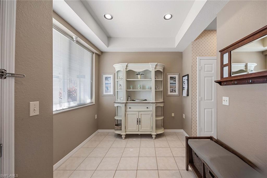 Undisclosed Address Naples, FL 34113 - Photo 10 of 38 a kitchen with a refrigerator and white cabinets