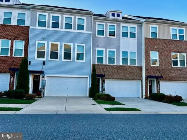 a front view of a house with a yard and a garage