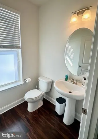 a white toilet sitting next to a bathroom sink