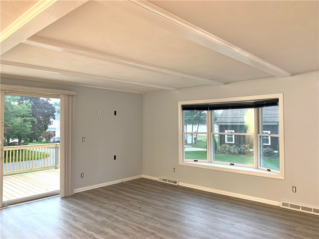 14 Baron Road Barrington, RI 02806 - Photo 7 of 37 Freshly painted interior, new plank flooring, oversized sliders and bow window maximize the afternoon natural light.