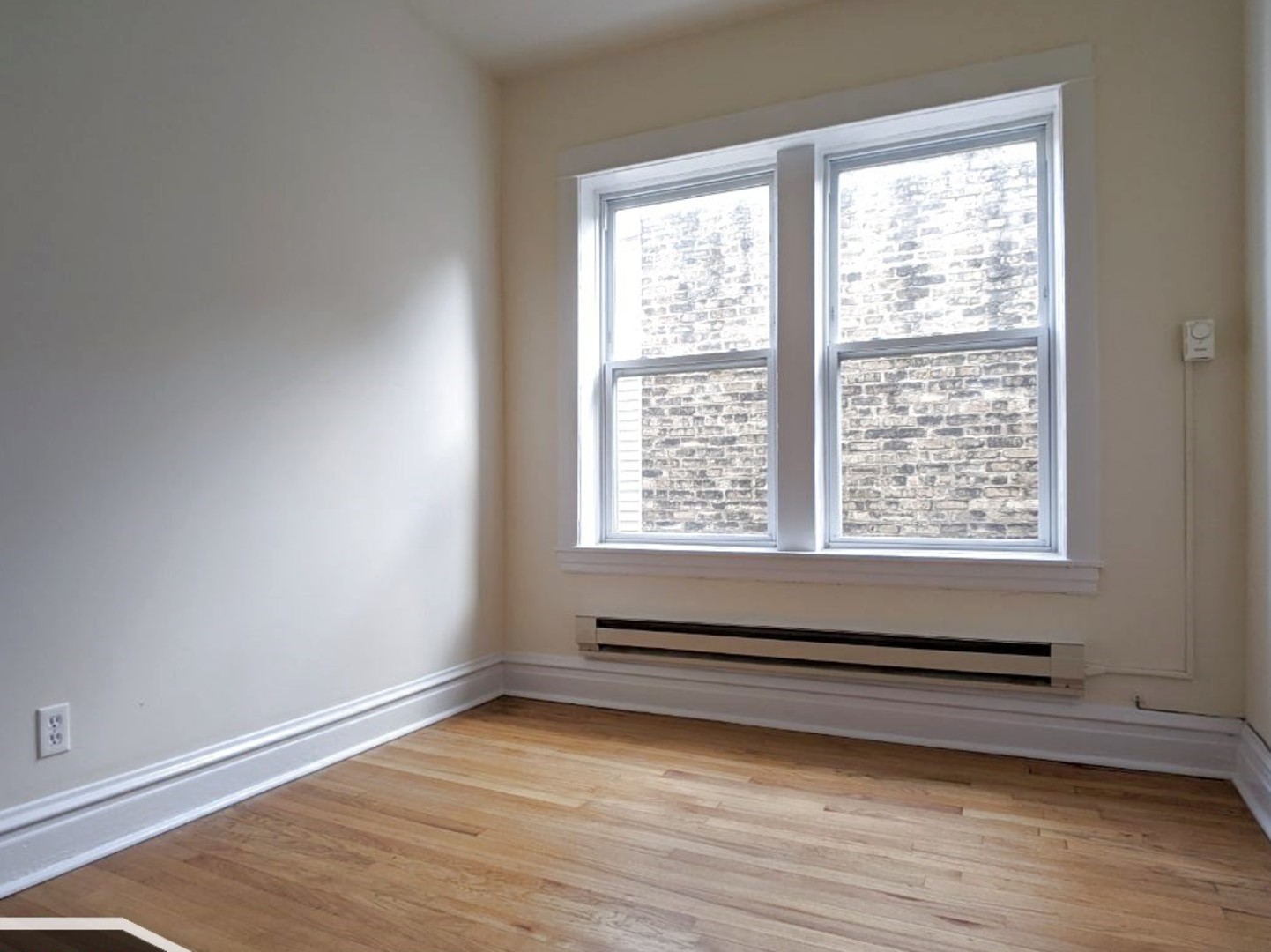 2919 West George Street, Unit 2 Chicago, IL 60618 - Photo 11 of 14 a view of a room with wooden floor and window