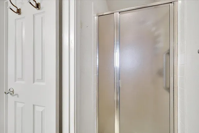 a bathroom with a glass shower door