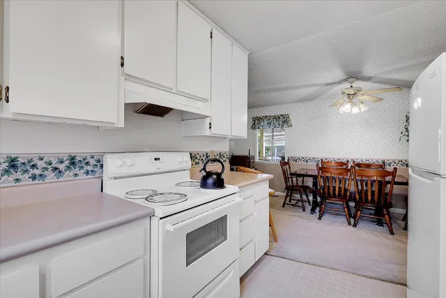 a kitchen with a stove and a dining table