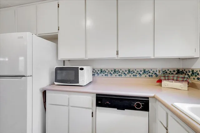 a kitchen with a refrigerator and a stove