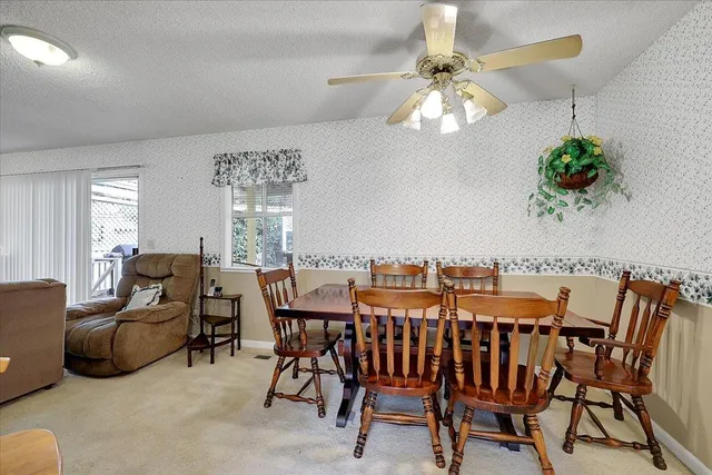 a view of a dining room with furniture wooden floor and chandelier