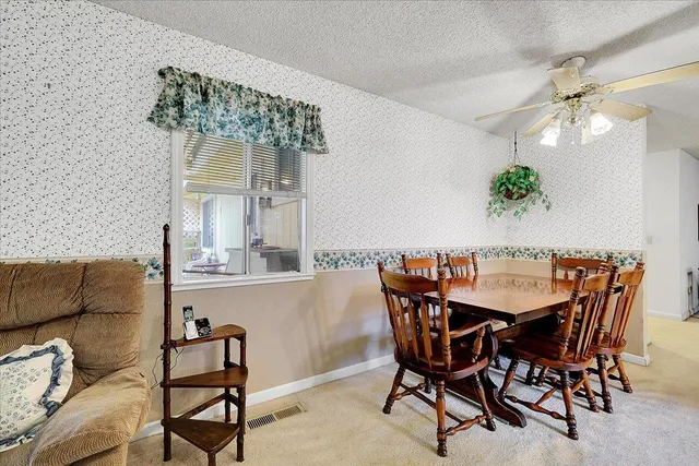 a dining room with furniture and window