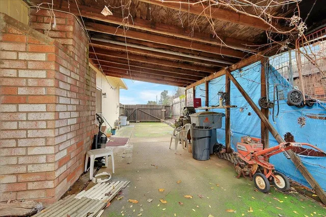 a view of a patio with table and chairs