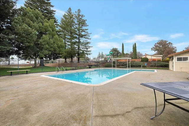 a view of a swimming pool and a yard