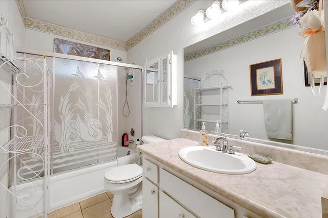 a bathroom with a sink toilet mirror and shower