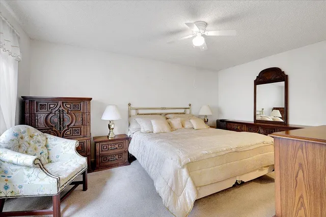 a bedroom with a bed couch and window