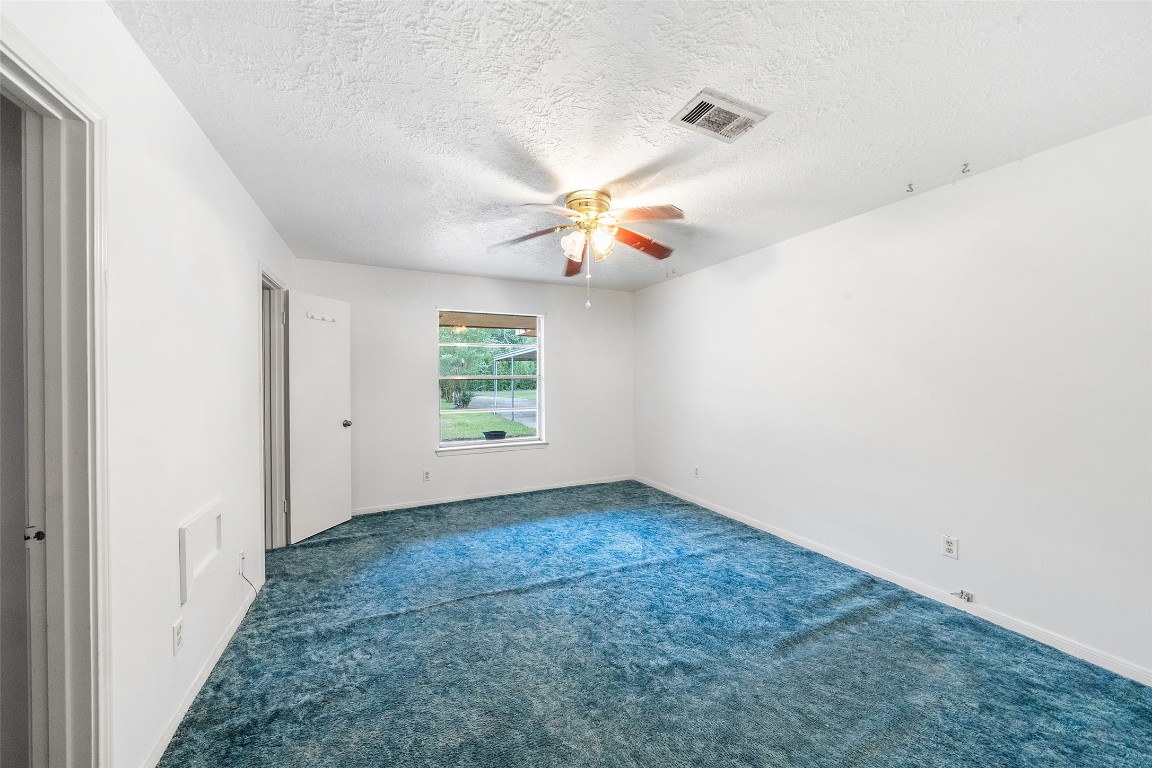 101 Walnut Coldspring, TX 77331 - Photo 20 of 37 an empty room with windows and fan