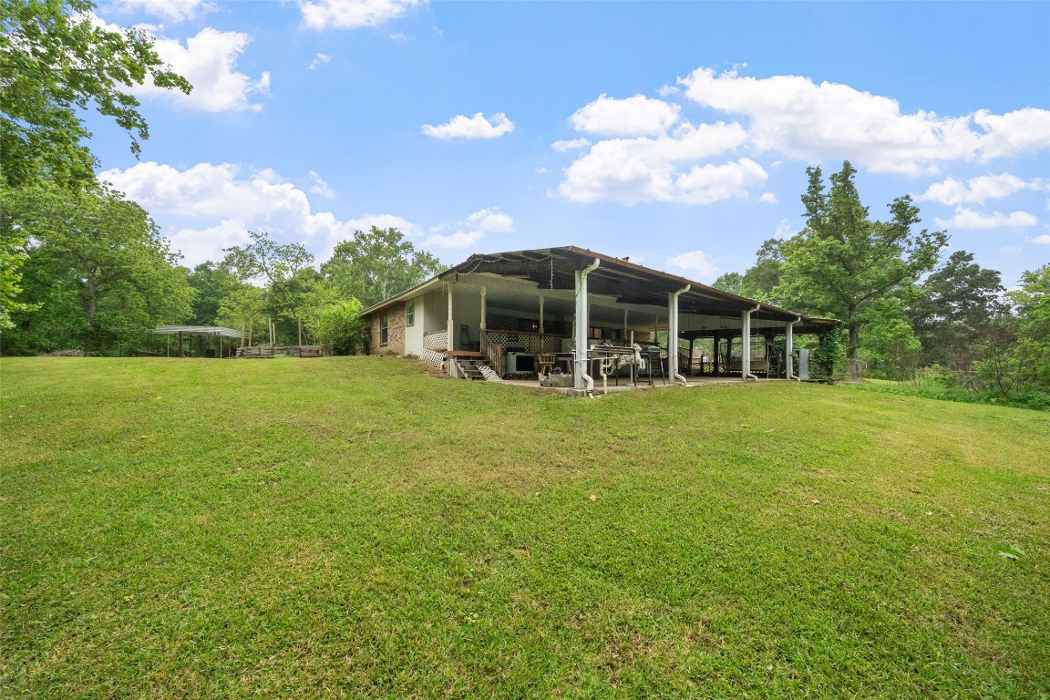 101 Walnut Coldspring, TX 77331 - Photo 29 of 37 a view of a house with a big yard and large trees