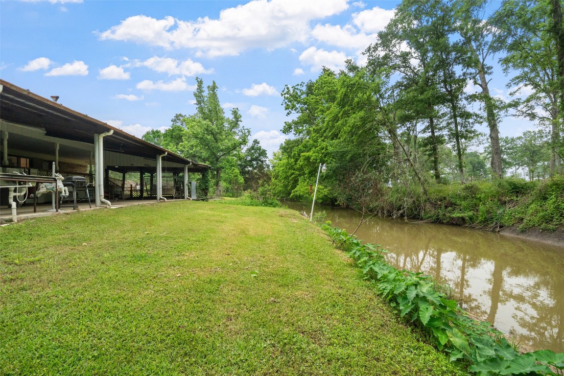101 Walnut Coldspring, TX 77331 - Photo 31 of 37 a swimming pool with outdoor seating and yard