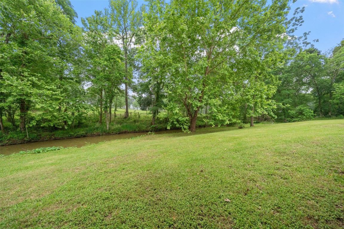 101 Walnut Coldspring, TX 77331 - Photo 32 of 37 a view of a field of grass and trees