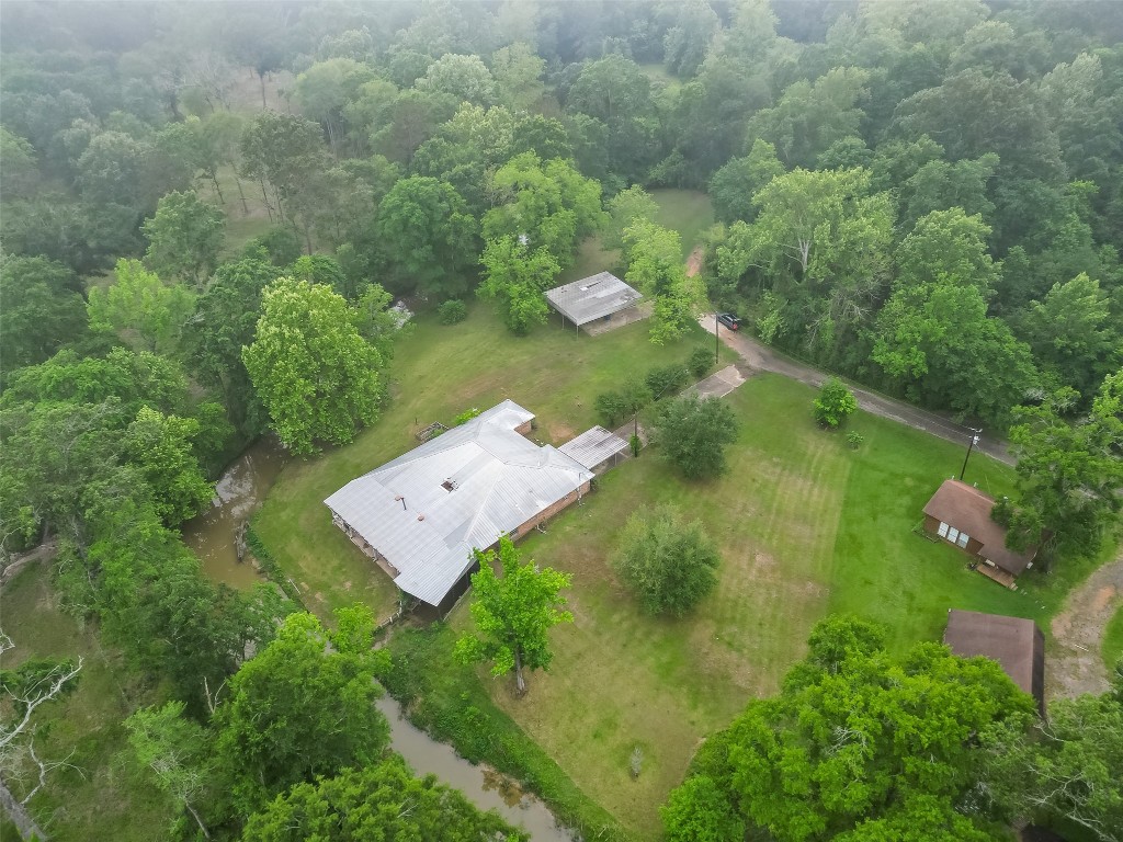 101 Walnut Coldspring, TX 77331 - Photo 5 of 37 an aerial view of a house with a yard