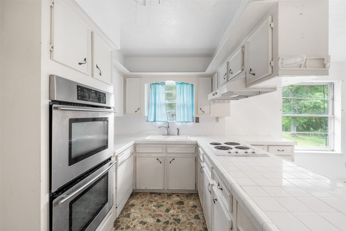 101 Walnut Coldspring, TX 77331 - Photo 8 of 37 a kitchen with granite countertop a stove sink and microwave
