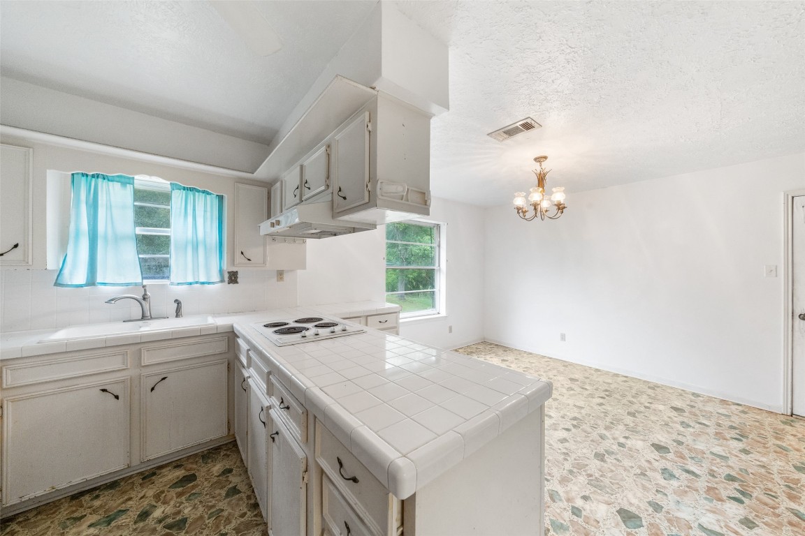 101 Walnut Coldspring, TX 77331 - Photo 9 of 37 a kitchen that has a sink and cabinets