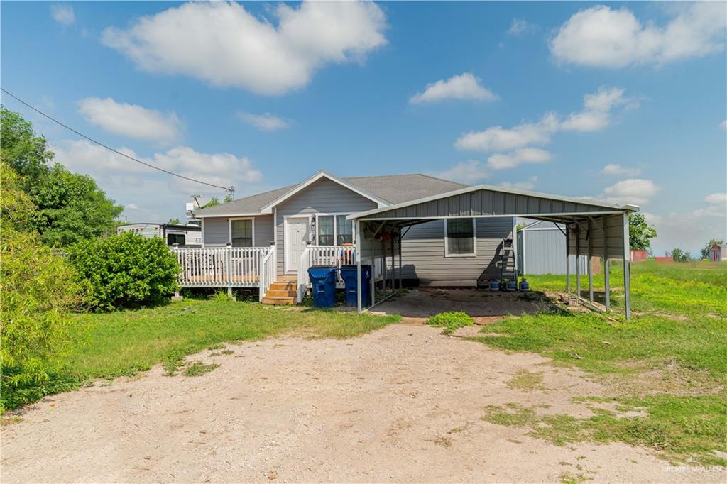 1115 East Canton Road Donna, TX 78537 - Photo 1 of 1 View of front of house featuring a carport and a front lawn