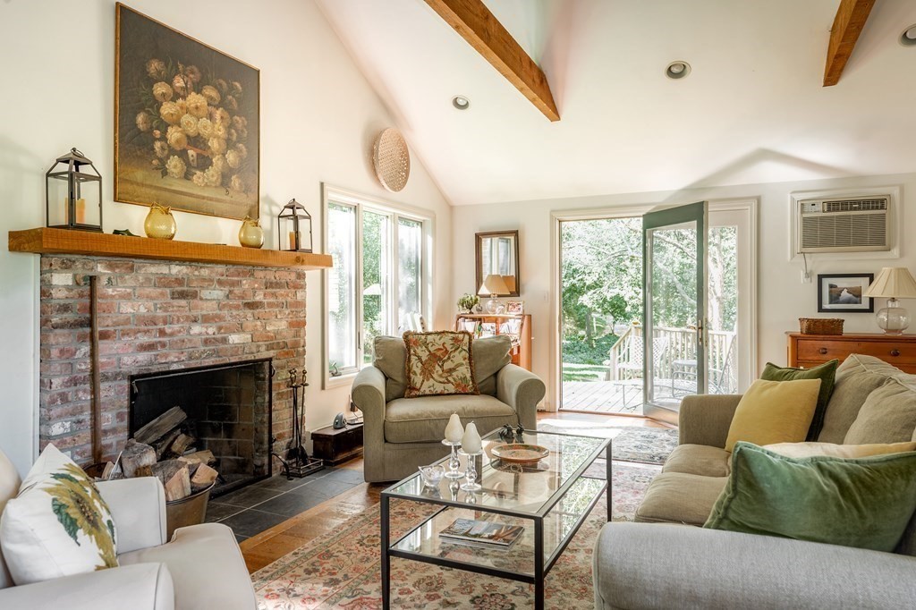 239 Argilla Road Ipswich, MA 01938 - Photo 11 of 37 a living room with furniture a large window and a fireplace