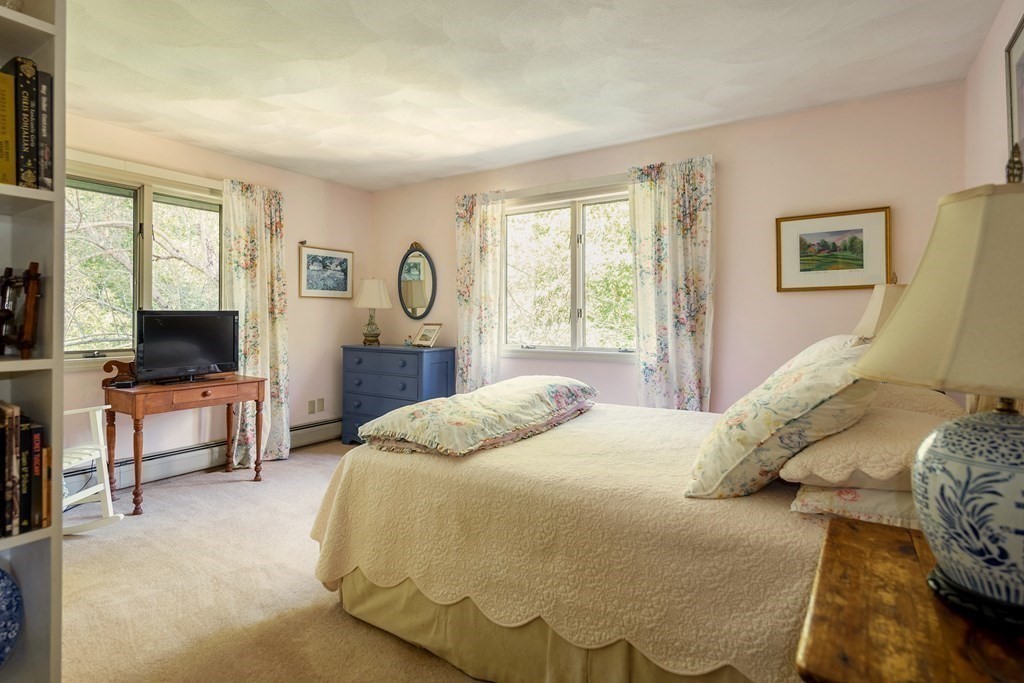 239 Argilla Road Ipswich, MA 01938 - Photo 16 of 37 a bedroom with a bed and a flat screen tv